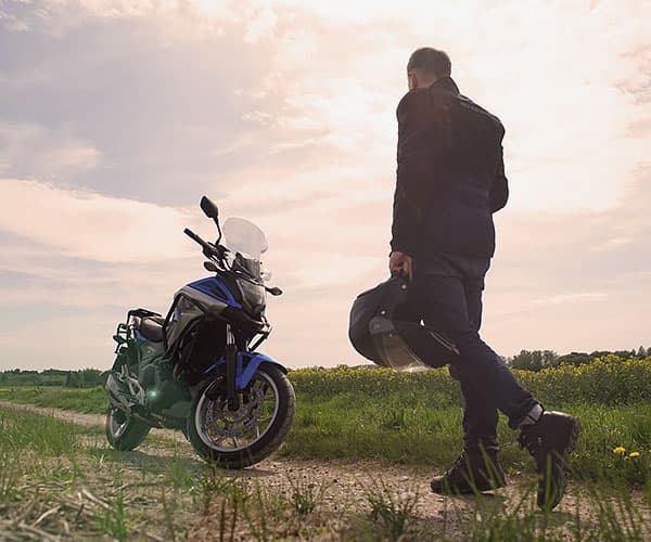 Guy walking toward motorcycle