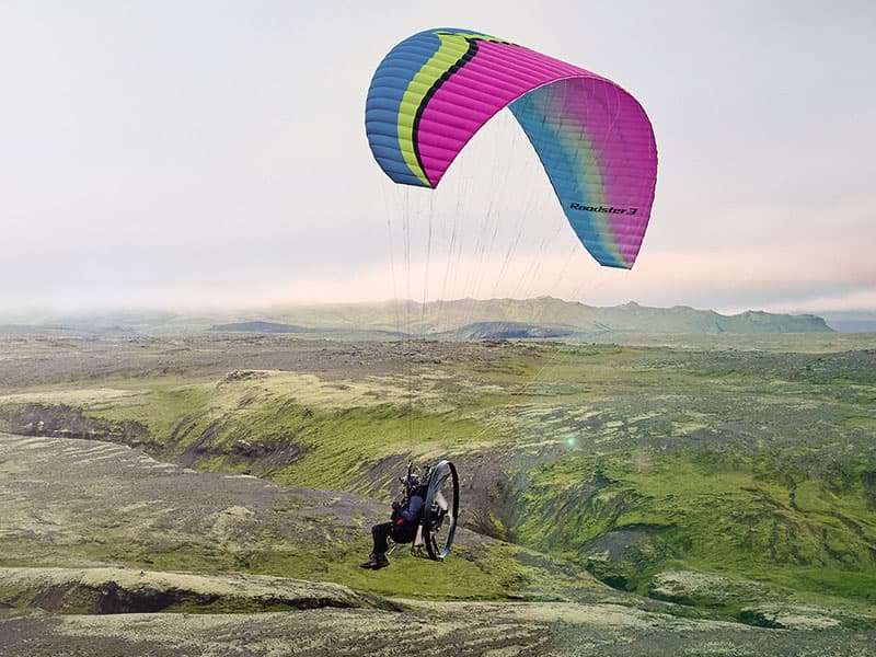 Aerial view of paramotor pilot flying