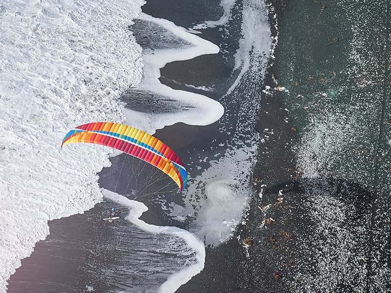 Aerial view of paramotor pilot flying