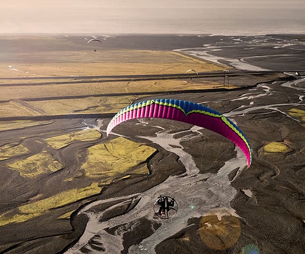 Paramotor pilot flying over Iceland